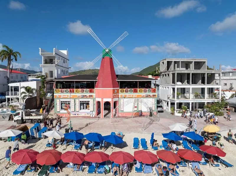 The red windmill and beach umbrellas in front of Dutch Blonde Beach Bar